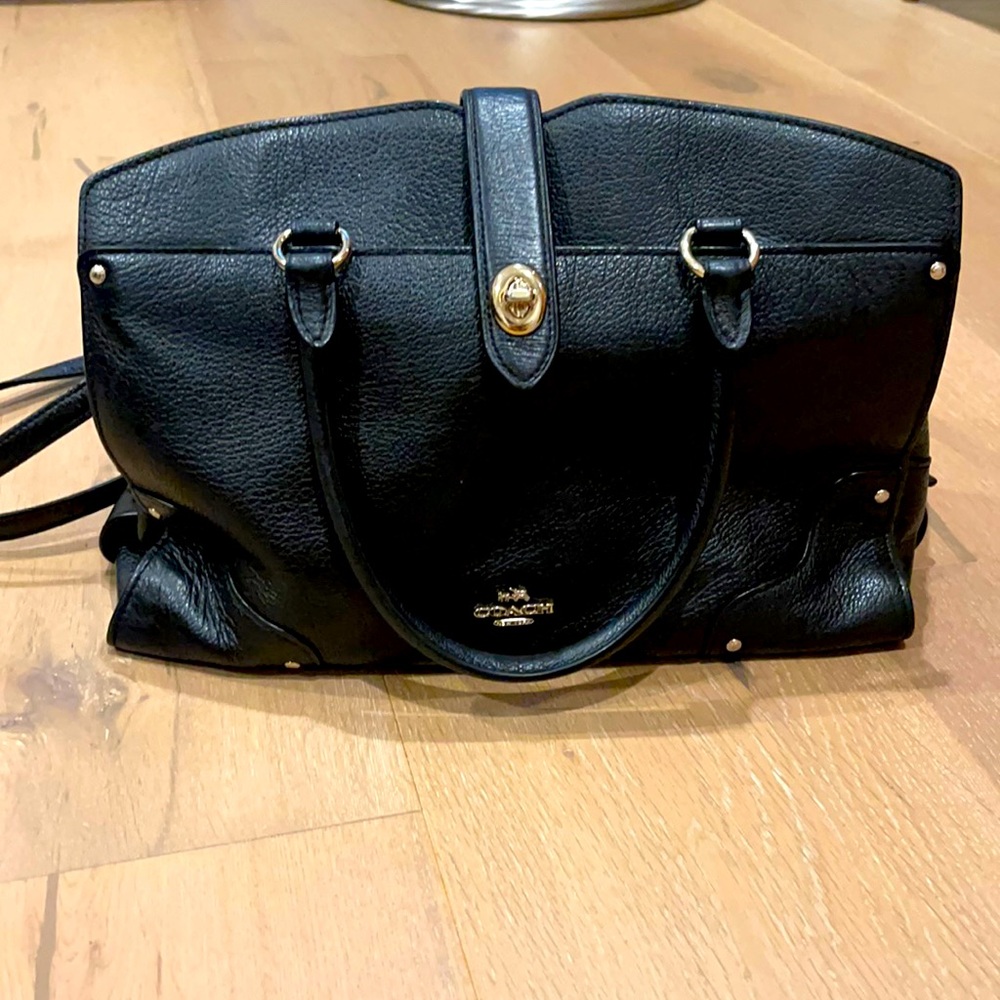 Black medium to large coach bag with a strap attached